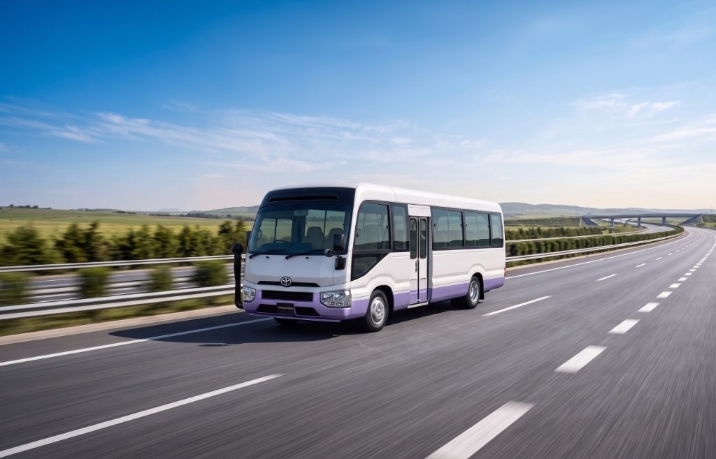 Toyota Coaster tourist bus for hire on a Bangladesh highway